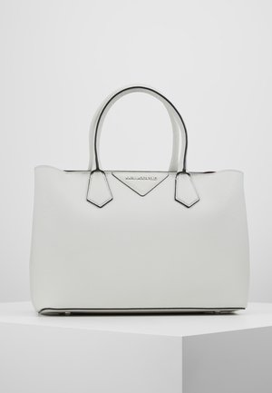 White structured tote bag with double handles, featuring a textured surface, contrasting black edges, and a logo accent on the front.