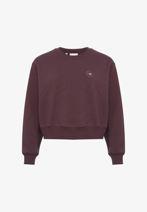 Bordeaux beskuren sweatshirt gjord av mjukt tyg. Har en ribbad halsringning, långa ärmar och en liten grafisk logotyp på bröstet.