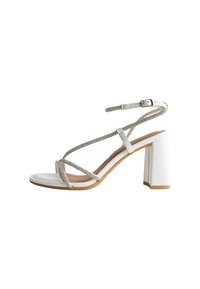 White heeled sandal with a square toe, featuring thin, crisscross straps adorned with silver accents and a block heel. Smooth finish.