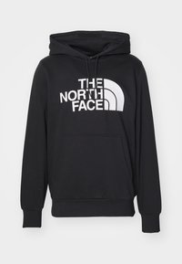 Felpa nera con cappuccio, caratterizzata da un grande logo e grafiche bianche "THE NORTH FACE" sul fronte, dotata di cappuccio e tasca a marsupio.