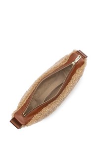 Soft beige shearling bag with a brown leather zippered top. Includes a smooth inner lining with a zipper pocket and double stitching details.