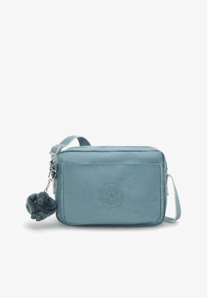 Light blue crossbody bag made of textured nylon. Features a zip closure, adjustable strap, and a detachable fluffy keychain charm.