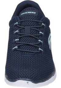 Navy blue mesh sneaker with a white sole. Features six pairs of lace eyelets and a Skechers logo on the side, with light blue accents.