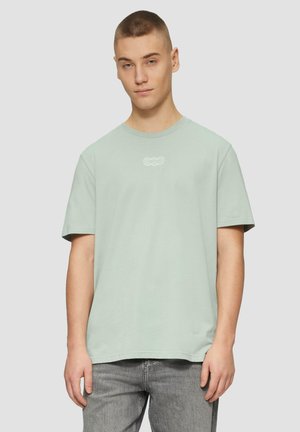 Light green cotton t-shirt with a crew neck and short sleeves, features a white graphic design on the chest. Available in a relaxed fit.