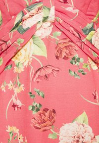 Růžová tkanina s plisováním obsahuje květinový vzor velkých růží a zelených listů v jemných odstínech krémové, růžové a červené.