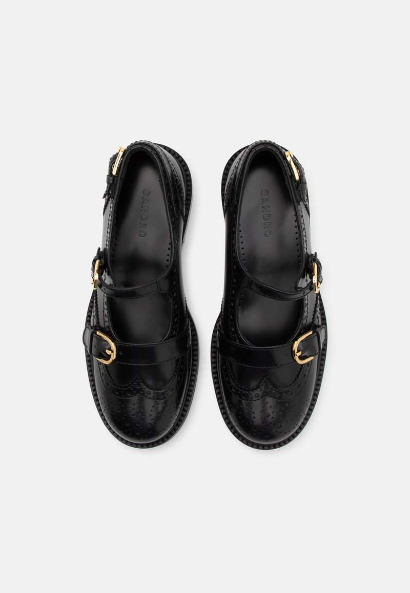 Zwarte lakleren schoenen met een ronde neus, gespdetail en geperforeerd wingtipsdesign. Platte zool en stiksels accent aan de zijkanten.
