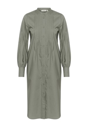 Zelené bavlněné šaty s dlouhými balónovými rukávy, zapínáním na knoflíky vpředu, vertikálními sklady a moderním límečkem. Design je do délky kolen a má volný střih.