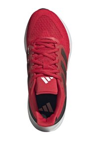 Zapatilla deportiva roja con parte superior texturizada, con acentos negros y logo blanco. Punta redondeada y suela acolchada visible desde la vista superior.