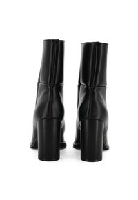 Stivali ankle in pelle nera con punta quadrata e tacchi alti e robusti. Presentano un design strutturato arricciato lungo i lati.