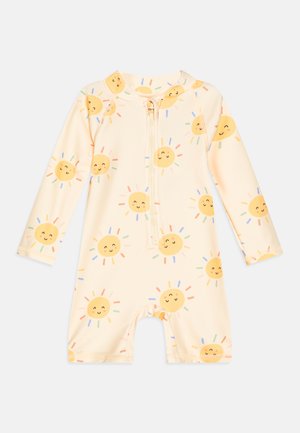 Maillot de bain une pièce à motif soleil jaune avec manches longues et fermeture éclair à l'avant, fabriqué en tissu doux et extensible.
