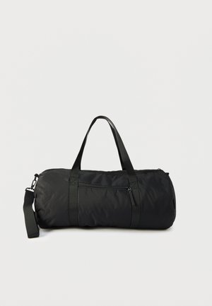 Black duffle bag made of nylon with a cylindrical shape, featuring two handles, a detachable strap, and a front zippered pocket.