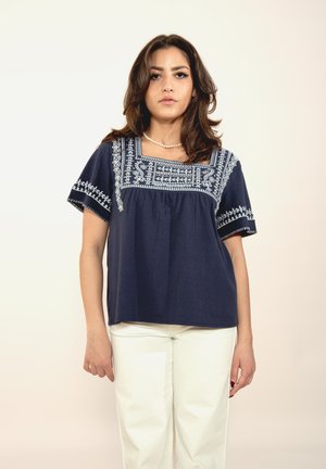 Navy blue cotton top with short sleeves, square neckline, and intricate light blue embroidery along the neckline and sleeves.