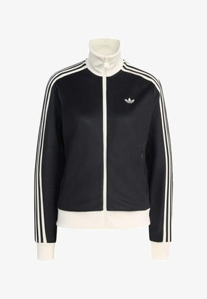 Crna sportska jakna s visokim ovratnikom, bijelim patentnim zatvaračem i dva bočna džepa. Sadrži bijele pruge duž rukava i mali logo na prsima.