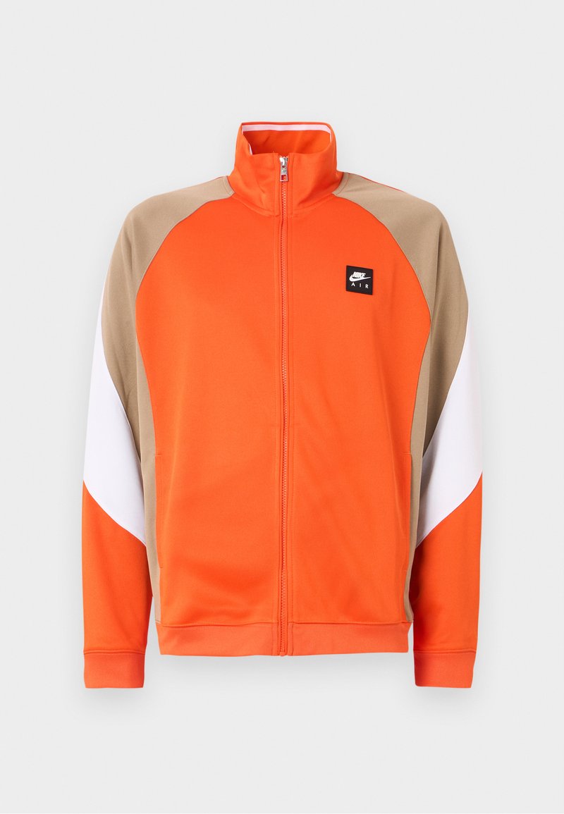 Oranger Reißverschlussjacke mit beige-weißen Akzenten, ausgestattet mit einem hohen Kragen und seitlichen Taschen. Hergestellt aus glattem, leichtem Stoff.