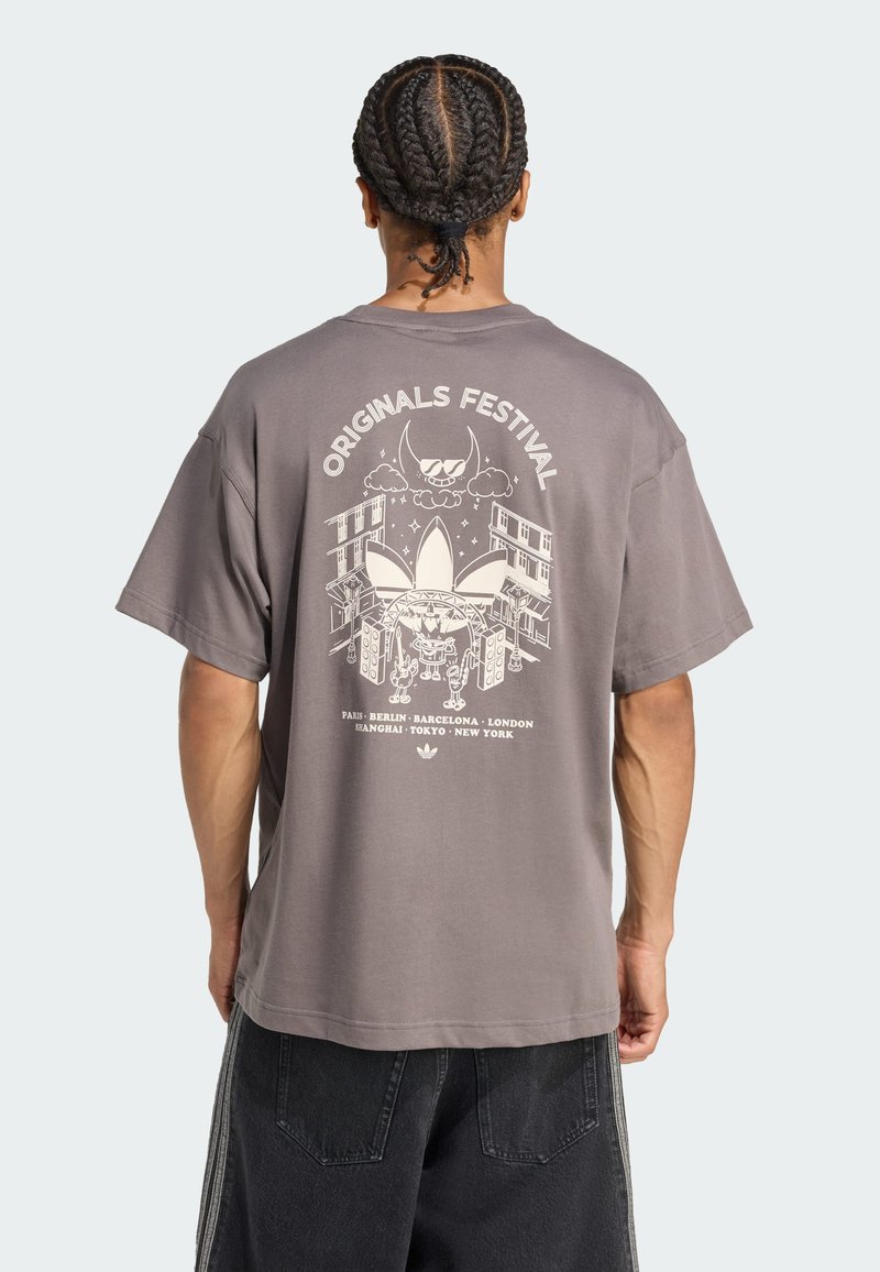 Gray oversized t-shirt, cotton material, features a graphic design on the back with "Originals Festival" text and city names.