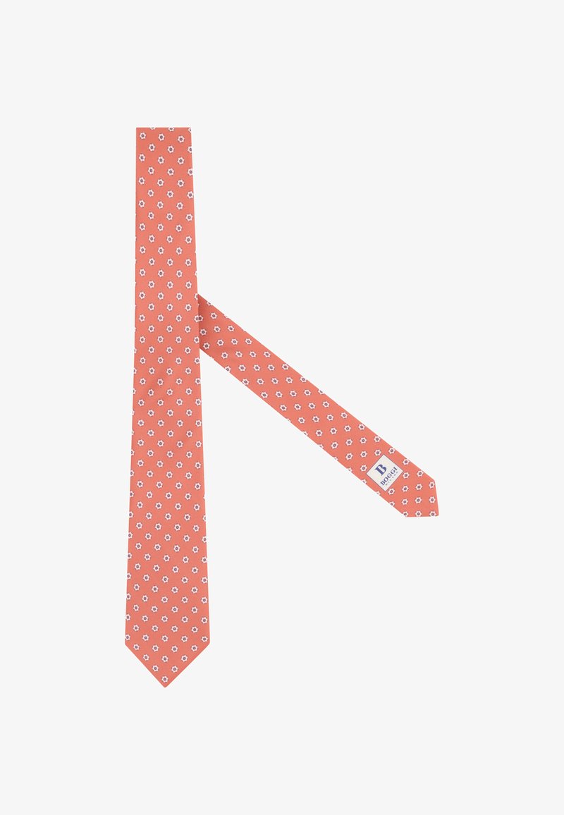 Cravate couleur corail avec un petit motif floral blanc et une étiquette visible au dos.