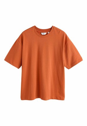 Rust-colored, short-sleeve cotton t-shirt with a crew neck and relaxed fit, hanging against a white background.