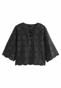 Blouse noire en coton avec manches larges, motif en dentelle à œillets circulaires, ourlet festonné et encolure en V.