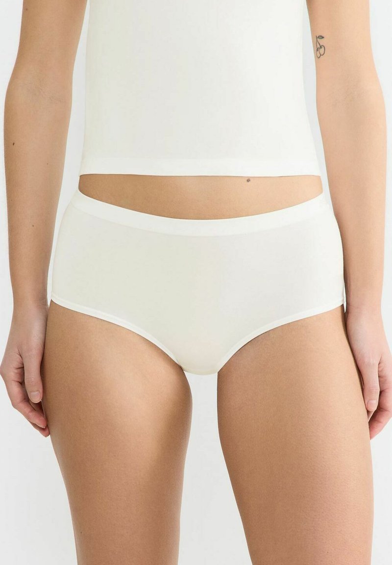 Naturale Baumwollslips in Off-White mit glatter Textur, elastischem Bund und kontrastierender weißer Borte entlang der Beine und Taille.