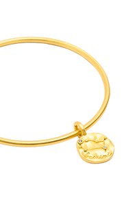 Bransoletka w kolorze złotym o gładkim, okrągłym fasonie. Posiada teksturowany charms przedstawiający konstelację Bliźniąt z dwoma małymi kamieniami.