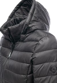 Black quilted puffer jacket with hood, front zipper, adjustable drawstring, and subtle logo on the upper sleeve.