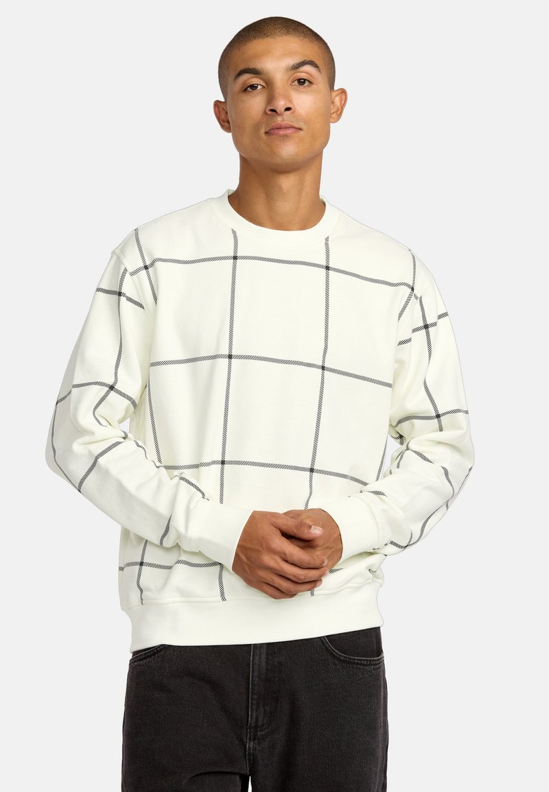 Lichtgekleurde sweatshirts met een zwart rasterpatroon. Bevat een ronde hals en ribgebreide manchetten, gemaakt van zachte stof. Draagt met donkere jeans.