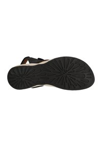 Sorte sandaler med en tekstureret gummisål, der har et blomstermønster. Overdelen inkluderer en kontrastfarvet beige sektion for stabilitet og stil.