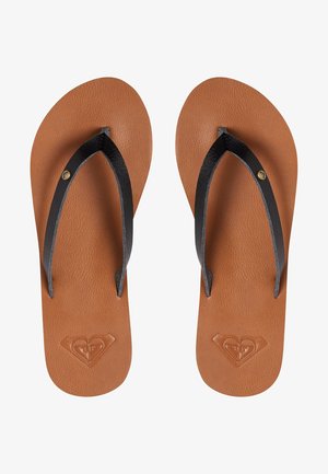 Pruunist kunstnahast sussid mustade rihmadega, millel on tekstuuriga jalatoed ja südametähtsusega märk, mis on pressitud talla peale.