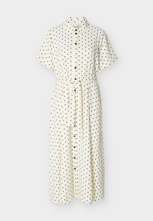 White midi dress with black polka dots, short sleeves, front buttons, collar, and a matching fabric belt at the waist.