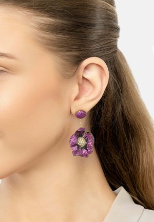 Purple floral earrings with glittering stones, a gold-tone metal base, and a textured stud design. Notable details include a central stone accent.