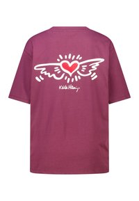 T-shirt violet en coton à coupe ample. Présente un graphisme blanc de cœur et d'aile dans le dos, ainsi que la signature "Keith Haring".
