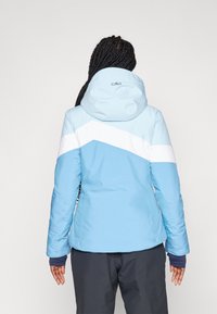 Lyseblå isoleret jakke med hætte, der har et hvidt chevronmønster. Struktureret stof med elastiske manchetter. Enkelt design.