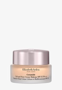 Słoiczek kremu z ceramidami do makijażu z matowym szklanym spodem i błyszczącą metaliczną pokrywką w kolorze różowego złota; oznaczony SPF 15 PA++; przezroczysty o gładkiej konsystencji.