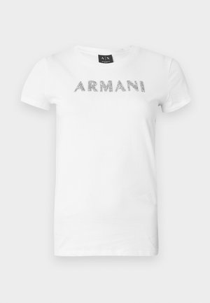 Baltas medvilninis marškinėlis su metalinio sidabro spalvos užrašu „ARMANI“ priekyje. Trumpomis rankovėmis ir apvalia iškirpte.