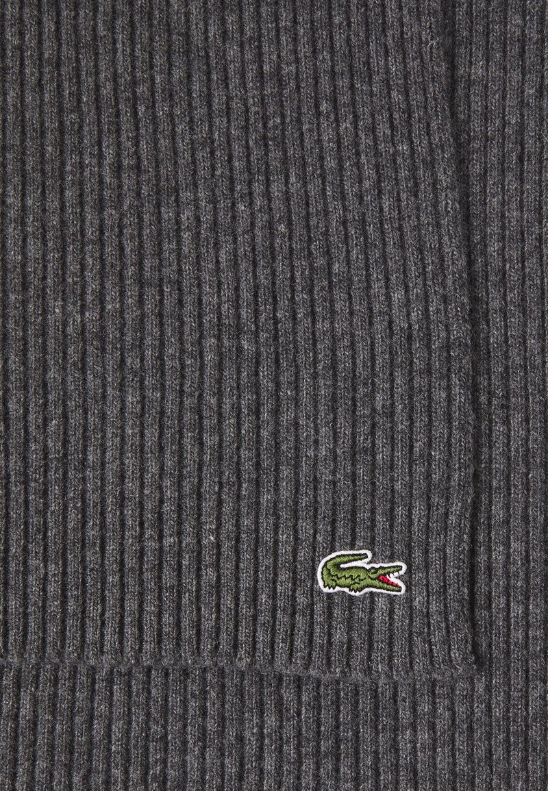 Dark gray ribbed knit scarf with a soft texture, featuring a small green embroidered crocodile logo on the lower corner.