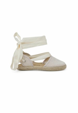 Scarpa espadrillas beige con tomaia in tela, suola in juta e sottili cinturini bianchi da legare attorno alla caviglia.