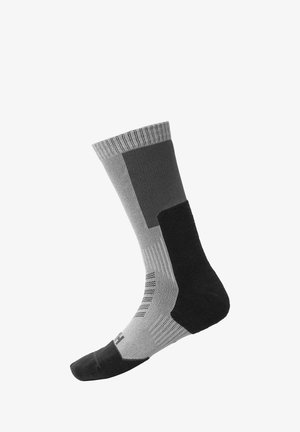 Calcetín negro y gris con textura acanalada. Presenta diferentes tonos, zonas de malla y puntera y talón reforzados. Longitud a media pantorrilla.