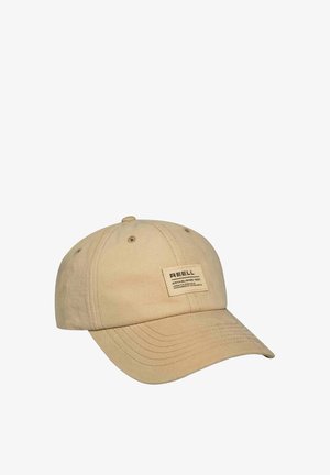Beige Baumwollbaseballmütze mit einem gebogenen Schirm, gestickten Details und einem rechteckigen Aufnäher mit der Aufschrift "REELL" auf der Vorderseite.