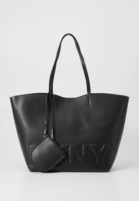 Black faux leather tote bag with high sides, embossed DKNY logo, and matching small zip pouch attached. Long, thin handles.