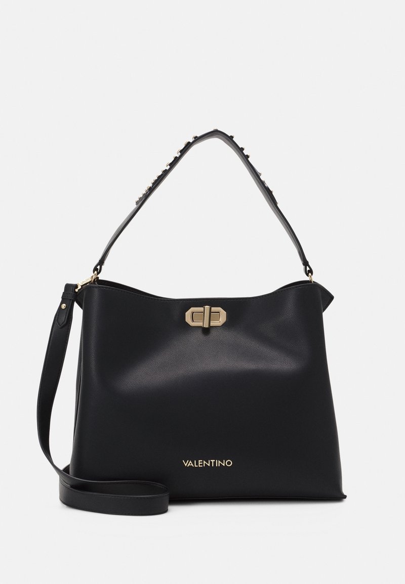 Black leather handbag with a structured shape, gold hardware, and a decorative studded strap. Features embossed brand name at the base.