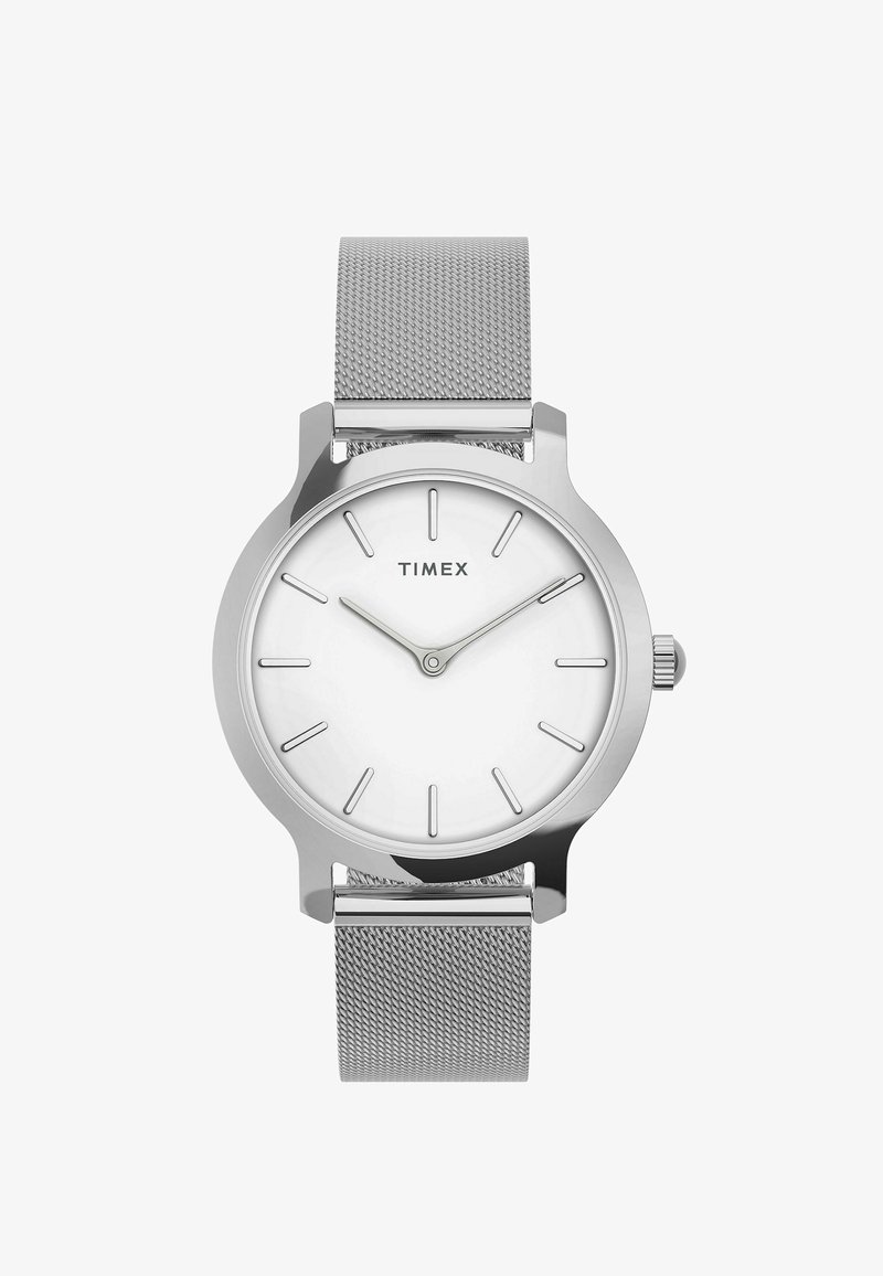 Montre Timex argentée avec cadran blanc, index horaires minimalistes, deux aiguilles indiquant 10h10, et un bracelet en maille métallique tissée.