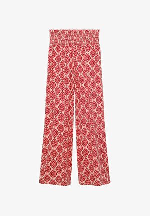 Breda byxor med smockat midjeband, med ett mönster i röd och krämfärgad geometrisk design. Tillverkade av lätt tyg med en mjuk textur.