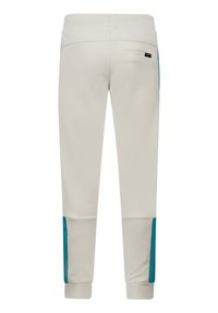 Crème-kleurige joggers met een taps toelopende fit, voorzien van teal accenten aan de zijkanten en een achterzak met een label. Soepele, elastische tailleband.