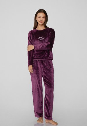 Purple velvet loungewear set featuring a crew neck long-sleeve top with "good night" embroidery and matching pants with an elastic waistband.