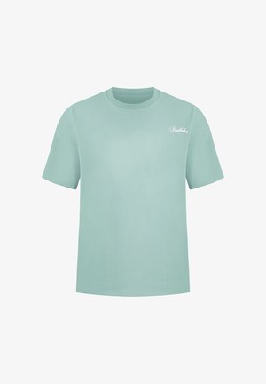 Camiseta de manga corta y cuello redondo de color azul claro con pequeño logo de texto blanco "Smokedon" en el pecho izquierdo.