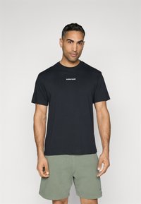 Black cotton t-shirt with short sleeves and crew neck, featuring a small white "BJÖRN BORG" logo centered on the chest.
