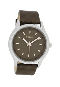 Brown leather strap watch with a round silver case. Dark brown dial featuring rose gold hour markers and hands. Minimalist design.