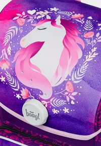 Zaino con un design in gradiente viola, caratterizzato da un unicorno bianco, una criniera rosa ondeggiante, accenti floreali e strass decorativi. Include un gancio circolare.