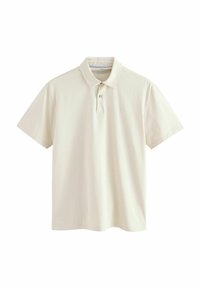Polo de algodón en color crema claro, con un cuello clásico, mangas cortas, tapeta de dos botones y un sutil bordado de logo en el pecho.