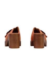 Orange suede block-heeled shoes with a smooth wooden heel and a bow detail on the side, featuring a rounded toe and flat sole.